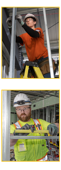 Two electrical workers with one stringing wire and the other measuring a building frame.