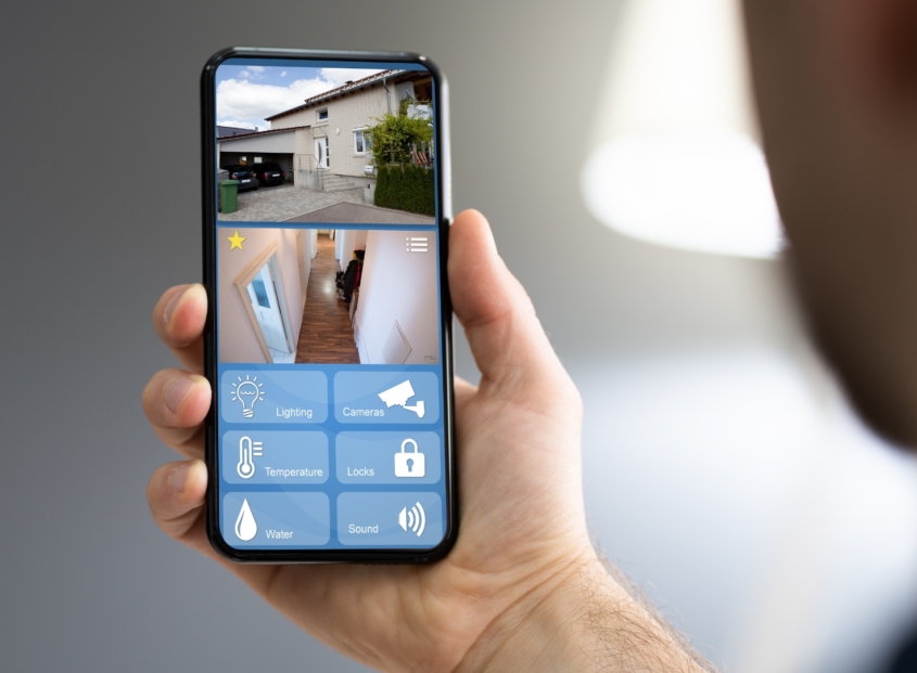 homeowner looking at smart phone technology.