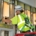 Man in safety gear installing electrical wiring.