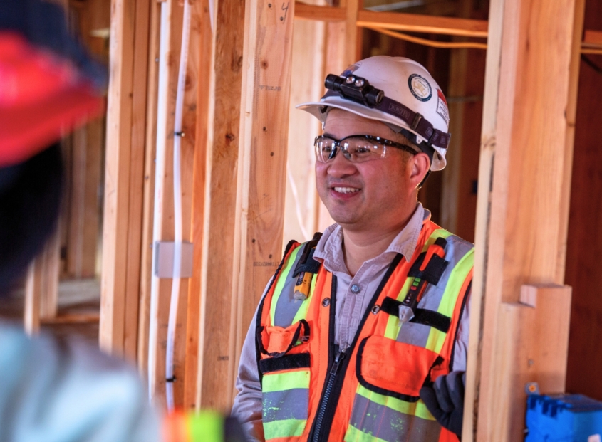 Two electrical professionals in a commercial building.