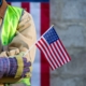 Construction worker holding the American flag.