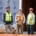 Four IBEW Local 48 union members wearing safety gear standing outside of a commercial building under construction.