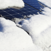 Residential solar panels covered in ice and snow.