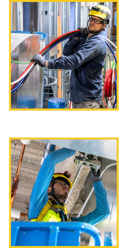 Two electrical workers with one stringing wire and the other measuring a building frame.