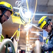 NECA-IBEW Local 48 electricians working on a warehouse's electrical infrastructure.