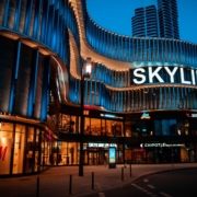 Nighttime exterior of Skyline Plaza with illuminated storefronts and wavy building facade.