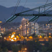 Portland skyline at night with electrical pole and wires.