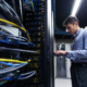 Worker on a data center typing at a terminal.